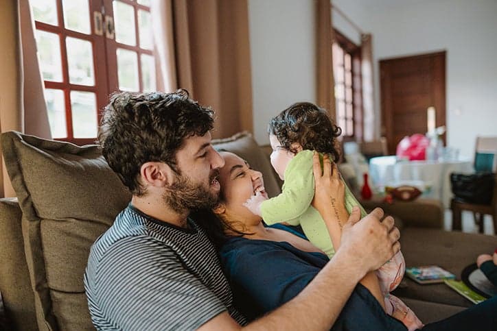 Mother and father holding newborn baby.